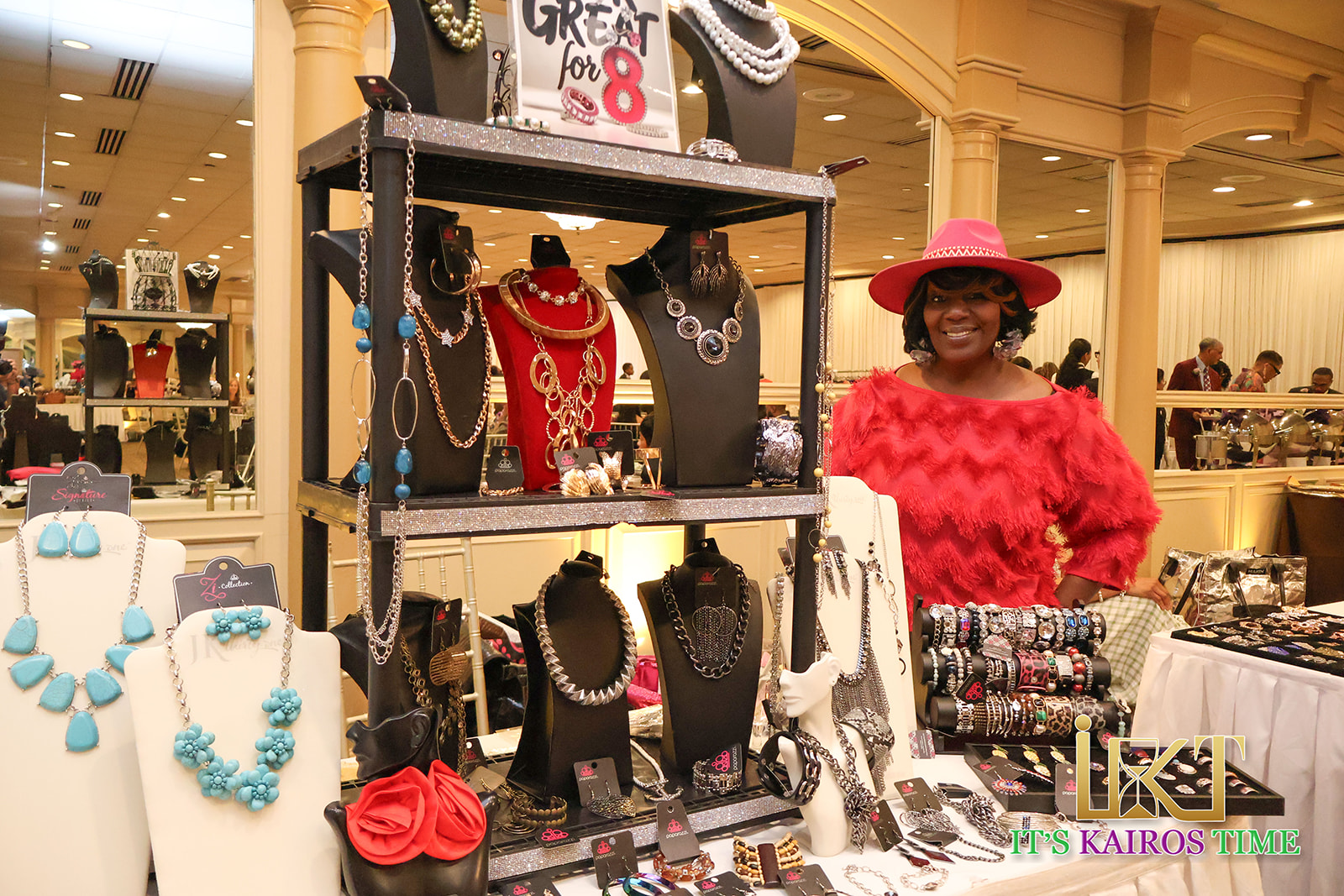 Jewelry vendor with bold red hat